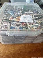 Large plastic tote filled with many loose baseball cards stacked inside.
