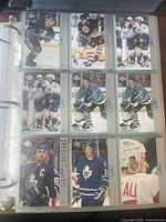 Full binder page showing nine NHL hockey cards including Boston Bruins, Toronto Maple Leafs, and Team Canada players.