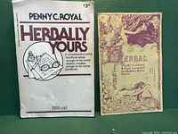 Photo showing two vintage herbal books: 'Herbally Yours' with a white cover and 'Herbae' with an illustrated beige cover