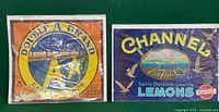 Front view of two vintage fruit and produce labels: Double A Brand East Apple Brand and Channel Santa Barbara County Lemons.