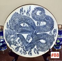 Full front view of circular plaque on wooden stand