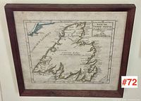 Frontal view of framed antique map showing entire wooden frame, glass surface, and map details