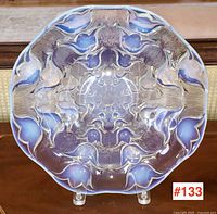 Front view of 12" diameter console plate in stand showing full Art Deco floral motif and scalloped edge.