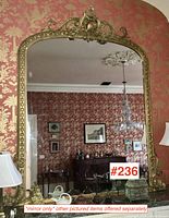 Full view of mirror installed over mantle against patterned wall