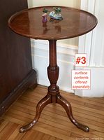 Full frontal view of the round top, turned column, and tripod base