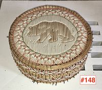Top view of lid showing central bear motif in porcupine quillwork and starburst border