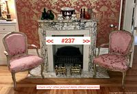 Two bergère chairs flanking marble mantel