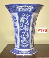 Front view of vase showing flared rim and floral panels