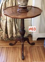 Full view of walnut candle stand with lamp for scale