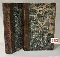 Two bound volumes showing half leather spines and marbled boards