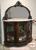 Front view of Victorian walnut sideboard with glass display doors, marble top, and carved mirror frame.