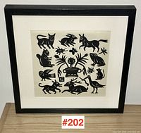 Full view of framed silhouette print on tabletop