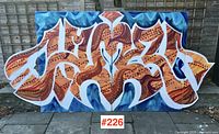 All four graffiti canvases arranged side by side outdoors against fence
