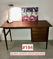 Front view of desk showing rectangular top and right-side drawer cabinet