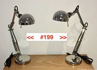 Full view of both desk lamps side by side on a wooden surface showing overall size, shape, and styling.