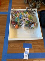 Plastic tray containing multiple colorful collectible matchbooks wrapped in plastic bags with ties.