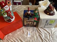Overview of tabletop decorations including snowman jar, elf shelf sitters, and Santa figurine