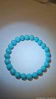 Top-down view of the turquoise bead bracelet showing color and bead consistency.