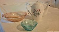 Group shot of Wedgwood teapot, pink ribbed glass bowl and aqua textured glass bowl