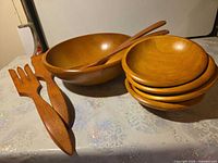 Full set showing large bowl, stacked small bowls, and two serving utensils