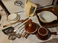 Entire lot showing mixer, porcelain bowl, utensils, drip-glaze stoneware and Pyrex bowl