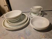 Stacks of bowls, plates, cups and saucers displaying pattern