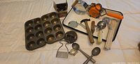 Group view of all bakeware and utensils on enamel tray