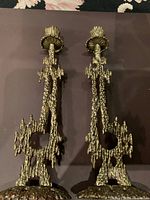 Front view of the pair of vintage Brutalist metal candle holders with detailed textured design