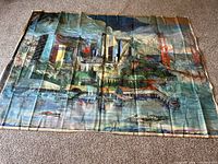 Full view of large San Francisco cityscape artwork on canvas laid flat on carpet.
