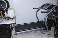 Side view of Nordic Track treadmill showing full length with belt and frame.