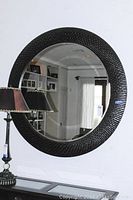 Full view of the round mirror hung on wall, showing overall shape and size