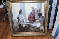 Full view of the framed square painting showing two men in historical robes inside a classical architectural setting.