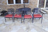 Four chairs in a row on stone patio showing front detail