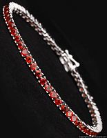 Full view of bracelet laid out on black background