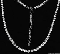 Close-up of the necklace's zirconia stone settings and chain extension.