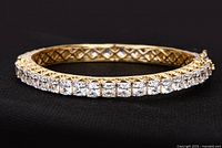 Angle showing front face and crystals of yellow gold plated 925 silver Swarovski bangle