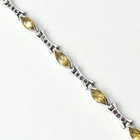 Close-up of the bracelet showing marquise-cut citrine stones and ruby-set silver links for color and design detail.