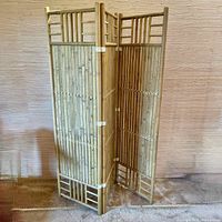 Full view of the bamboo folding room screen standing open showing three connected panels.