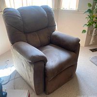 Front and side view of the electric recliner chair showing plush padded cushions in light tan fabric upholstery with no major damage.