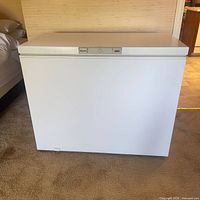 Front and side view of the white Wood's chest freezer showing size and condition.