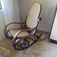 Front three-quarter view of curved bentwood frame and cane seat/back