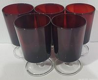 Five ruby red Luminarc Cavalier goblets grouped together showing their rich color and clear stems