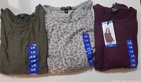Three Buffalo David Bitton ladies knit long sleeve tops, size Large, new with tags. Colors: olive green, light gray patterned, and dark burgundy.