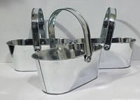 Three shiny silver metal baskets with handles, arranged to show front and side views.