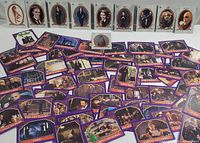 Full display of 60 Topps Addams Family collectible cards laid out showing various characters and movie scenes with a purple bordered design