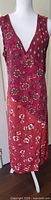 Front view of sleeveless, V-neck midi dress with mixed floral and geometric prints in red and pink tones on mannequin.