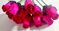 Closeup view of the vibrant fuchsia colored wooden roses highlighting petal detail and texture.