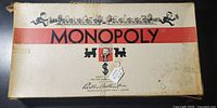 Original Monopoly box showing wear, discoloration and tape reinforcement on edges