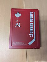 Front of red DVD case showing Canada Russia '72 with maple leaf, Soviet hammer and sickle, and hockey stick graphics