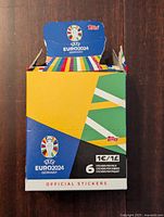 Front view of unopened colorful UEFA Euro 2024 Germany soccer sticker box with Topps logo and 6 stickers per pack information